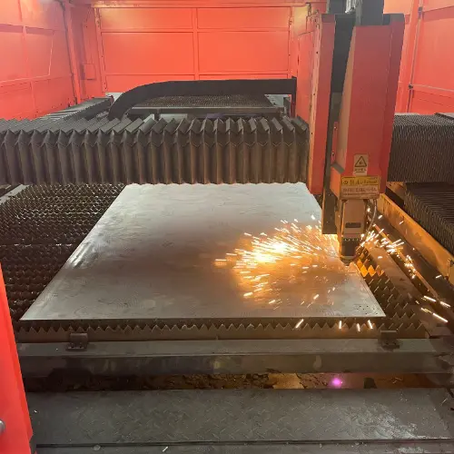 A CNC laser cutter precisely cutting intricate shapes from sheet metal for a rapid prototype.