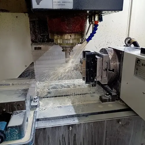 A 5-axis CNC milling machine precisely machining a complex prototype out of metal.